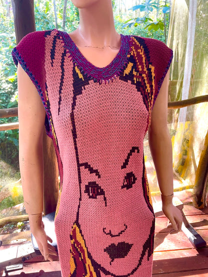 A mannequin wearing a crocheted dress with a face on it.
