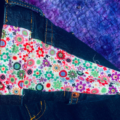 a pair of jeans with a patchwork design on them.