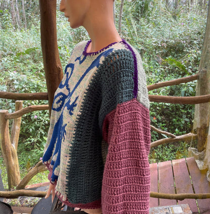 A mannequin mannequin wearing a crocheted sweater.