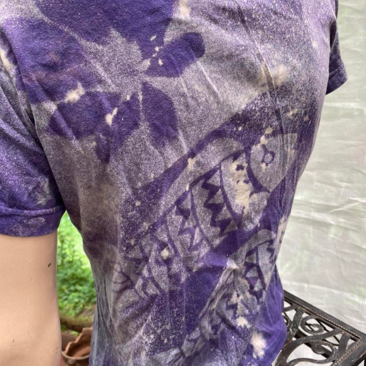 A woman wearing a purple tie dye t - shirt.