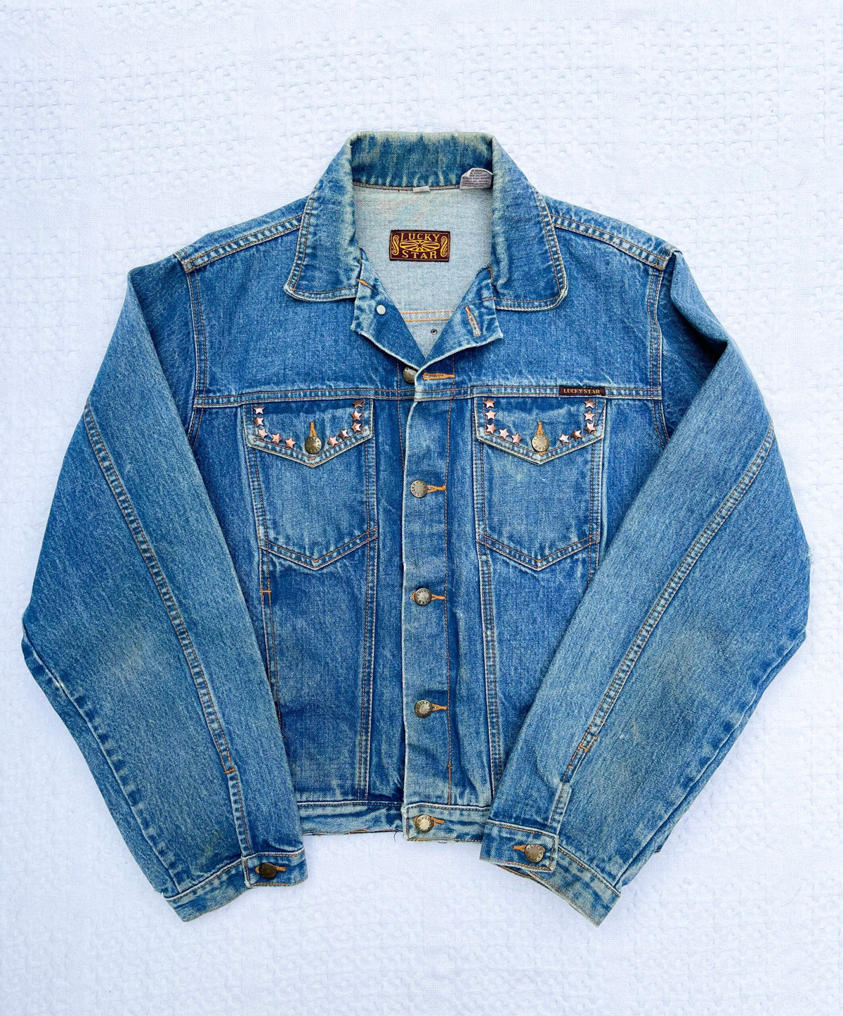 A denim jacket with a beading on it.