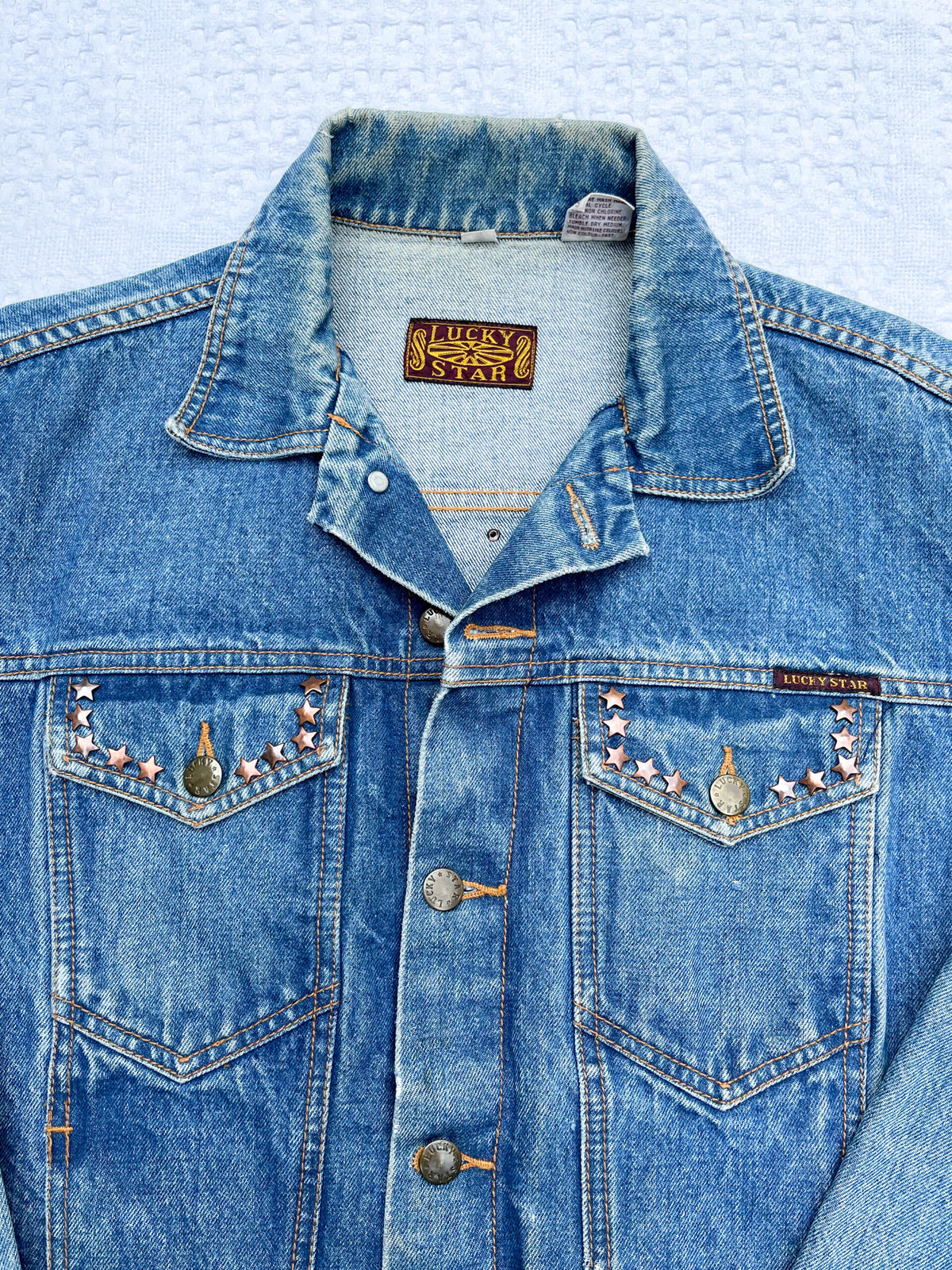 A denim jacket with studs on it.