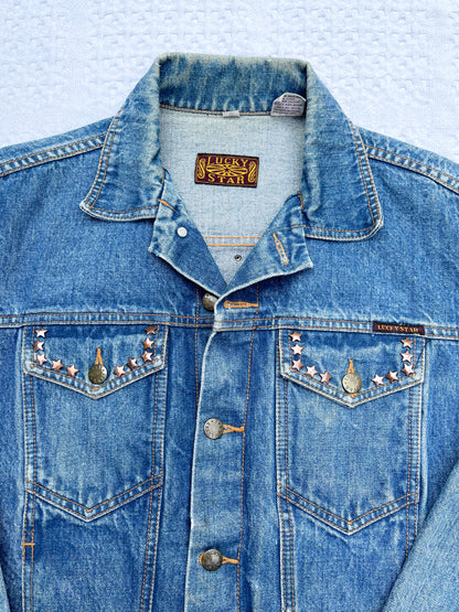 A denim jacket with studs on it.