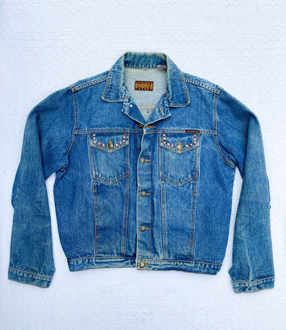 A blue denim jacket on a white background.