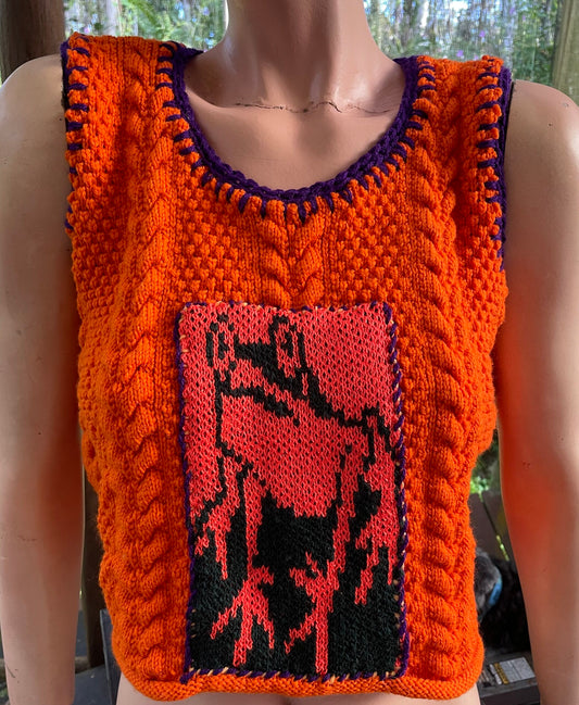 A bright orange knitted vest with a frog