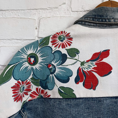 A denim jacket with flowers on it.