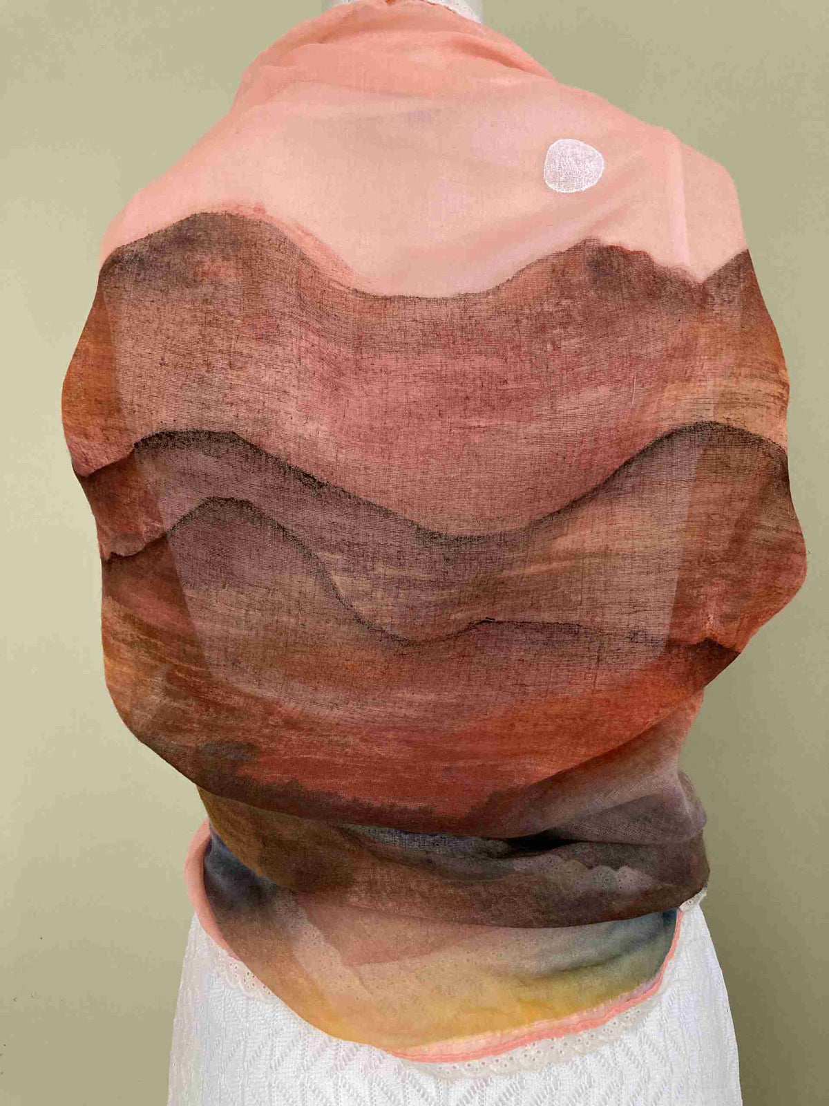 a woman's head is covered in a piece of fabric.