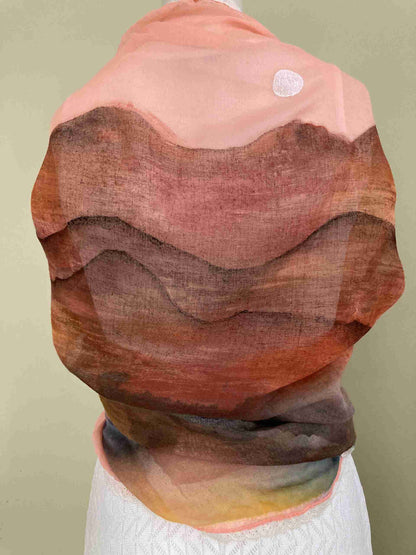 a woman's head is covered in a piece of fabric.