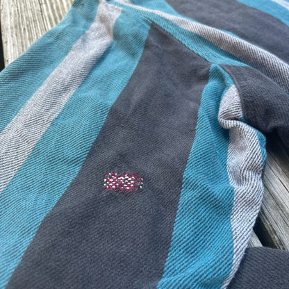 A close up of a blue and grey striped shirt.