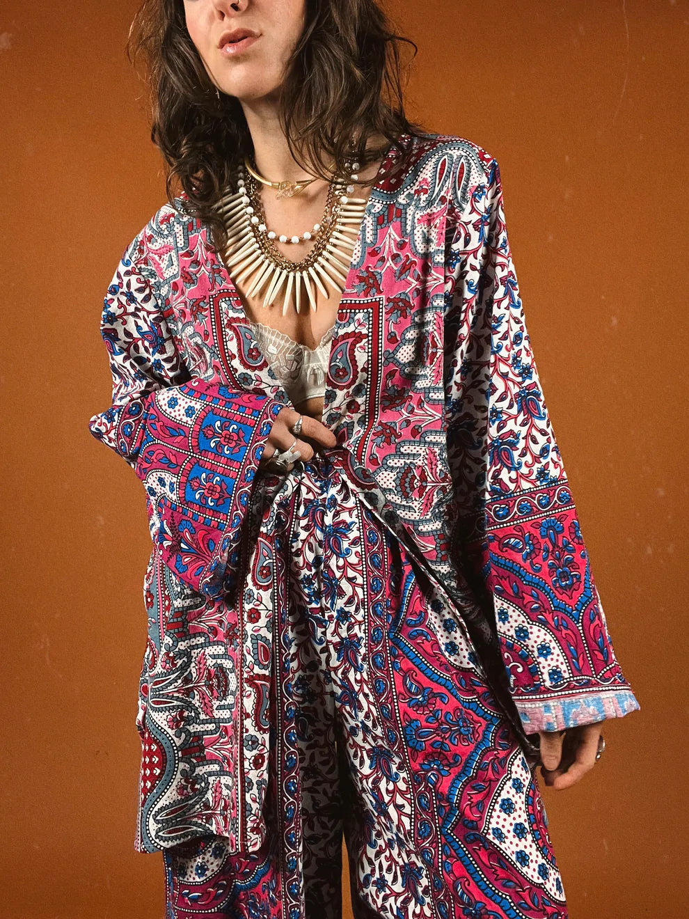 a woman in a colorful dress poses for a picture.