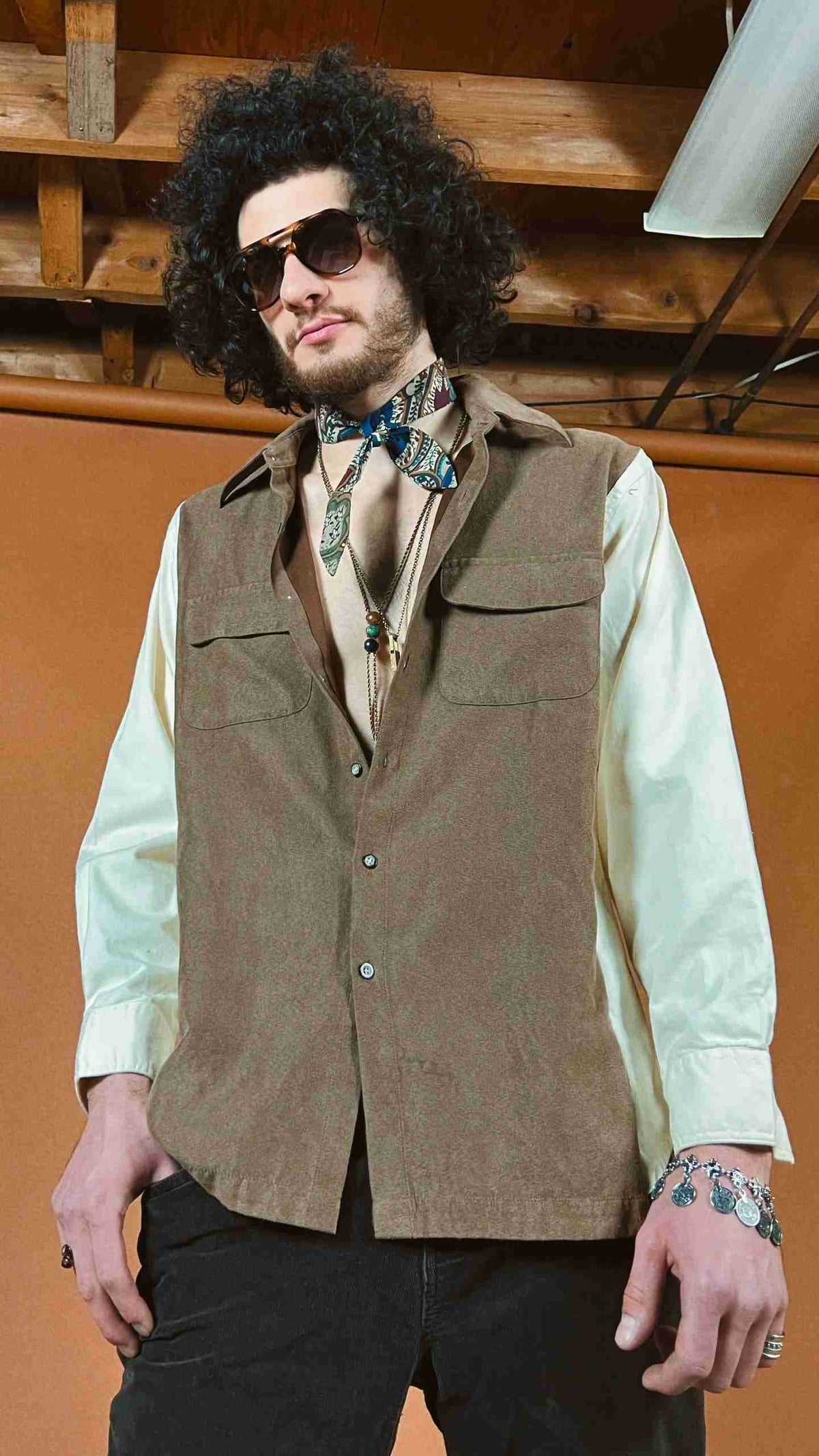 a man wearing a brown vest and a bow tie.