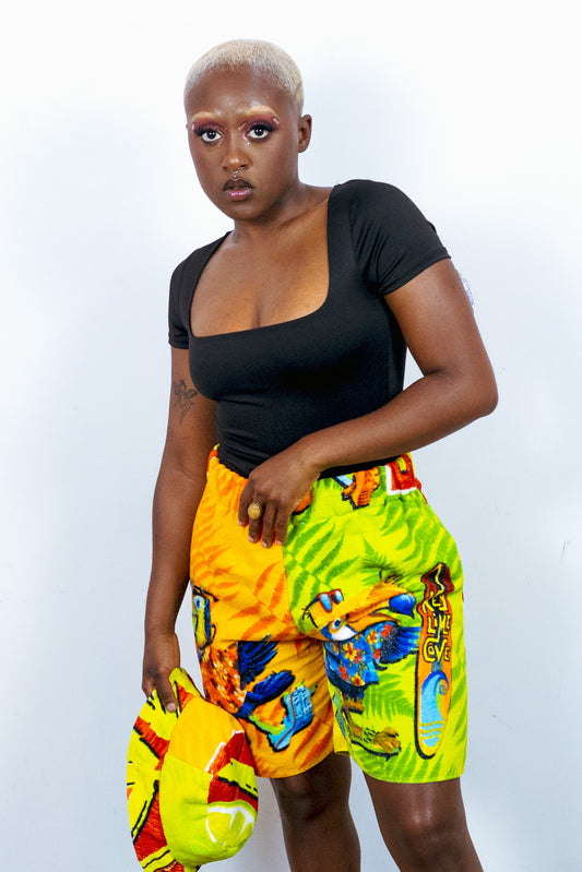 a woman in a colorful shorts posing for a photo.