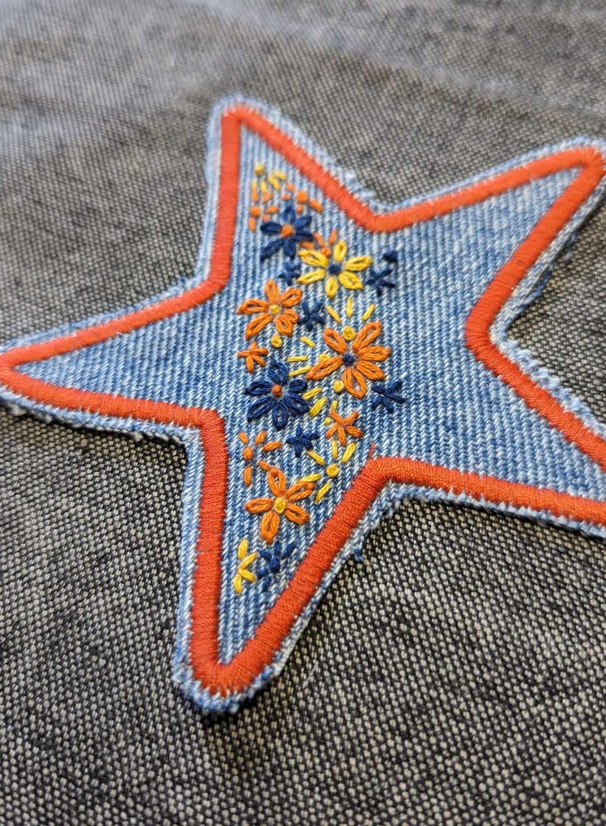 A star embroidered on a piece of denim.