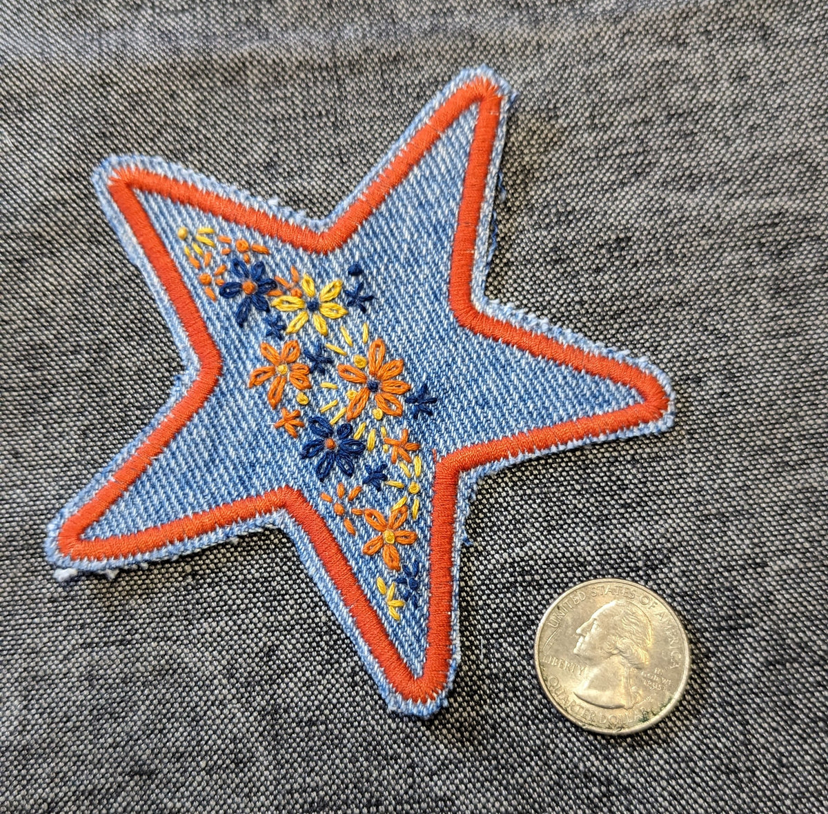 A star embroidered on a piece of denim.
