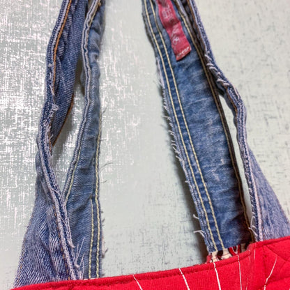A red denim tote bag with a red zipper.