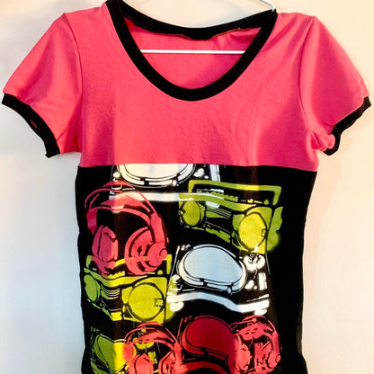 A pink and black t - shirt with headphones on it.