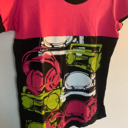 A pink and green t - shirt with headphones on it.
