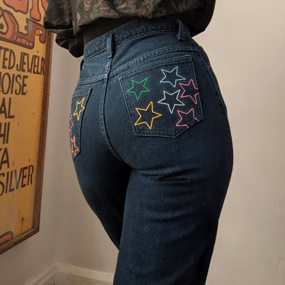 A woman wearing Reworked Embroidered Rainbow Star Pocket Jeans.