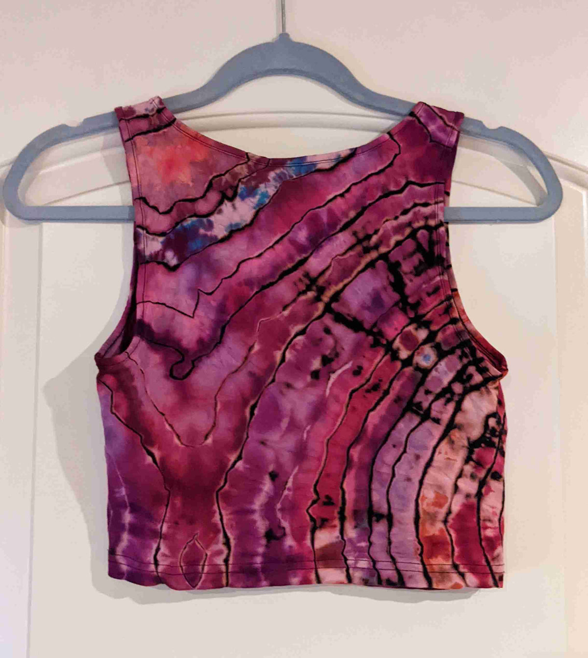 a tank top hanging on a hanger.