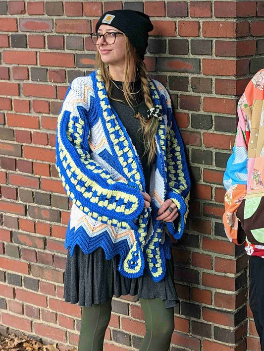 Model is wearing crochet cardigan.