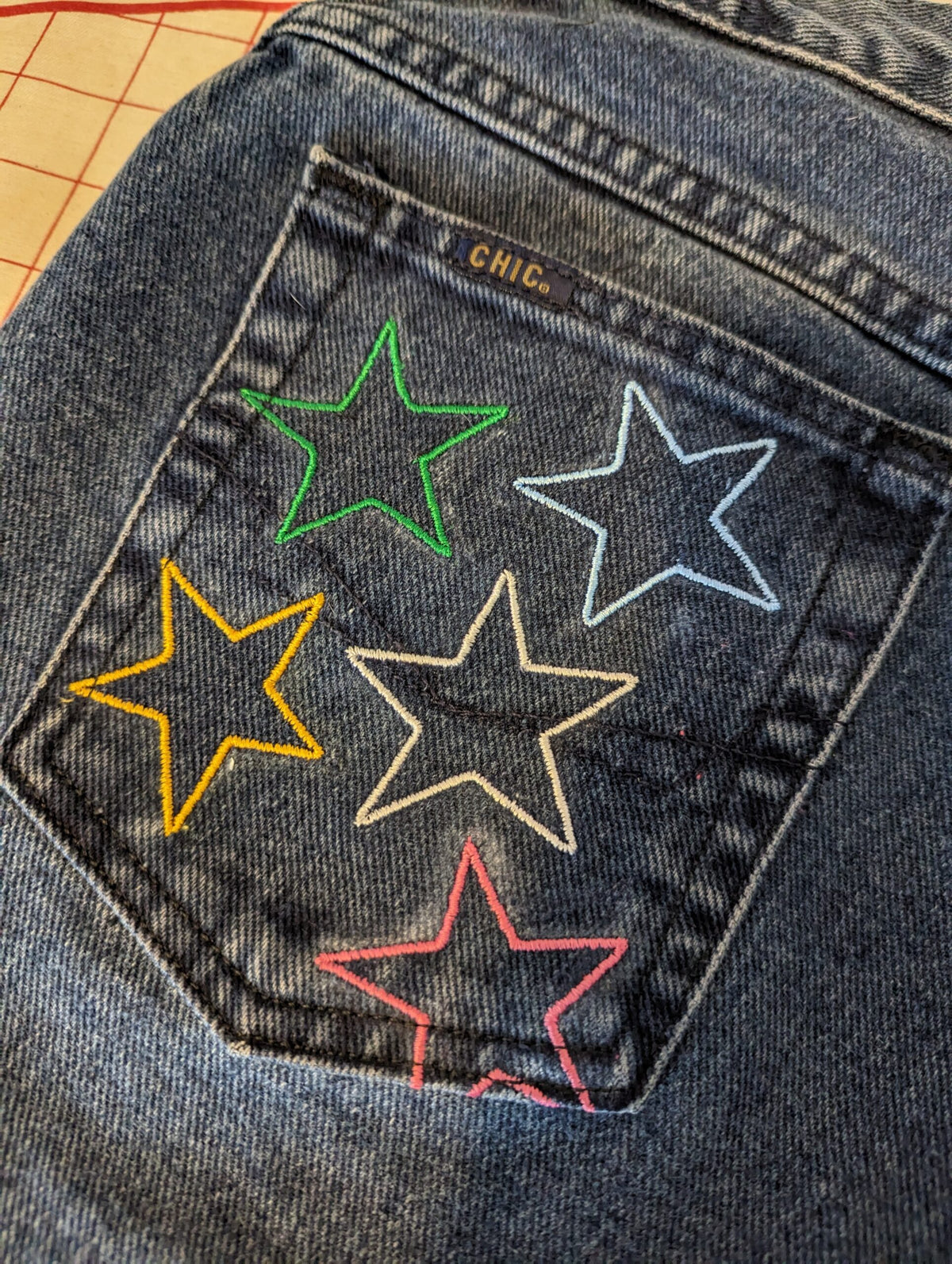 Rainbow Star Jeans with rainbow colored stars on them.