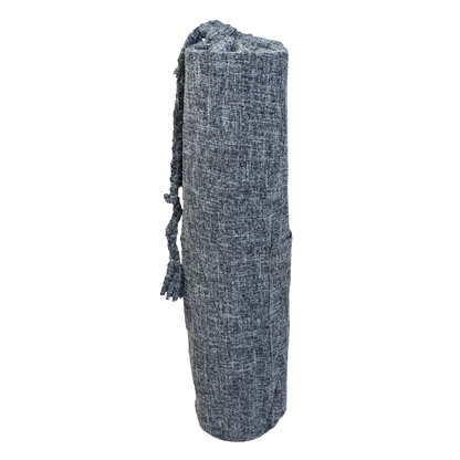 A grey yoga mat with tassels on it.