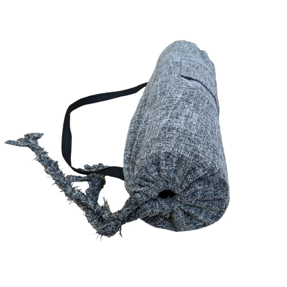 A grey yoga mat with a black strap.