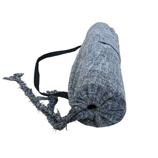 A grey yoga mat with a black strap.