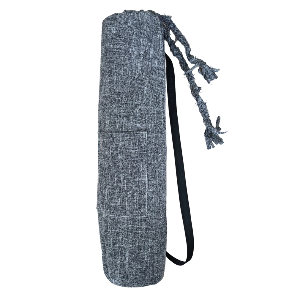 A grey yoga bag with black straps.