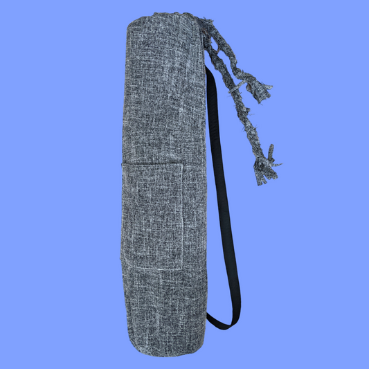 A gray yoga bag on a blue background.