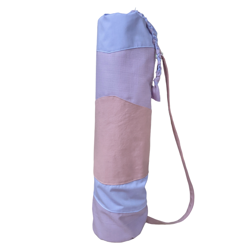 A pink and blue yoga bag with a strap.