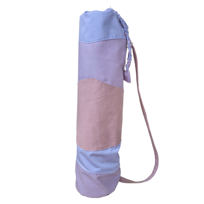A pink and blue yoga bag with a strap.