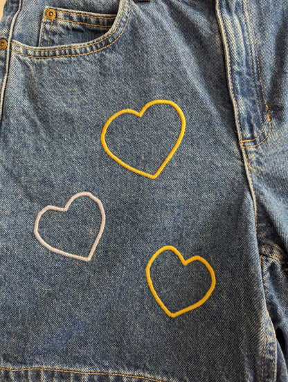 A pair of Embroidered Heart Shorts.
