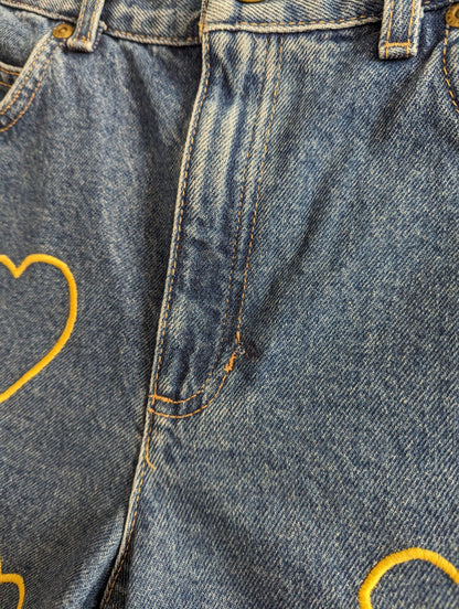 A pair of Embroidered Heart Shorts.