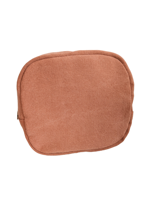 A small orange pouch on a black background.