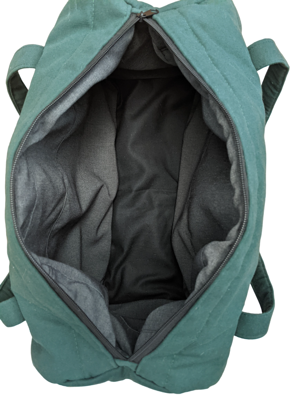 The inside of a teal duffel bag.