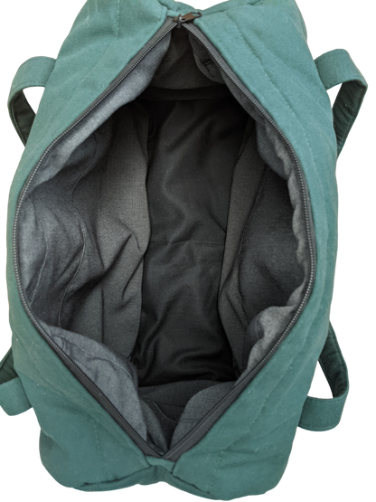 The inside of a teal duffel bag.