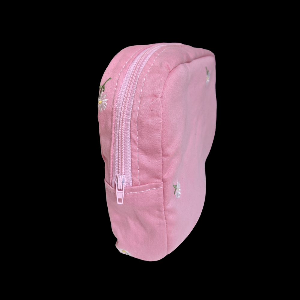 A pink zippered pouch on a black background.