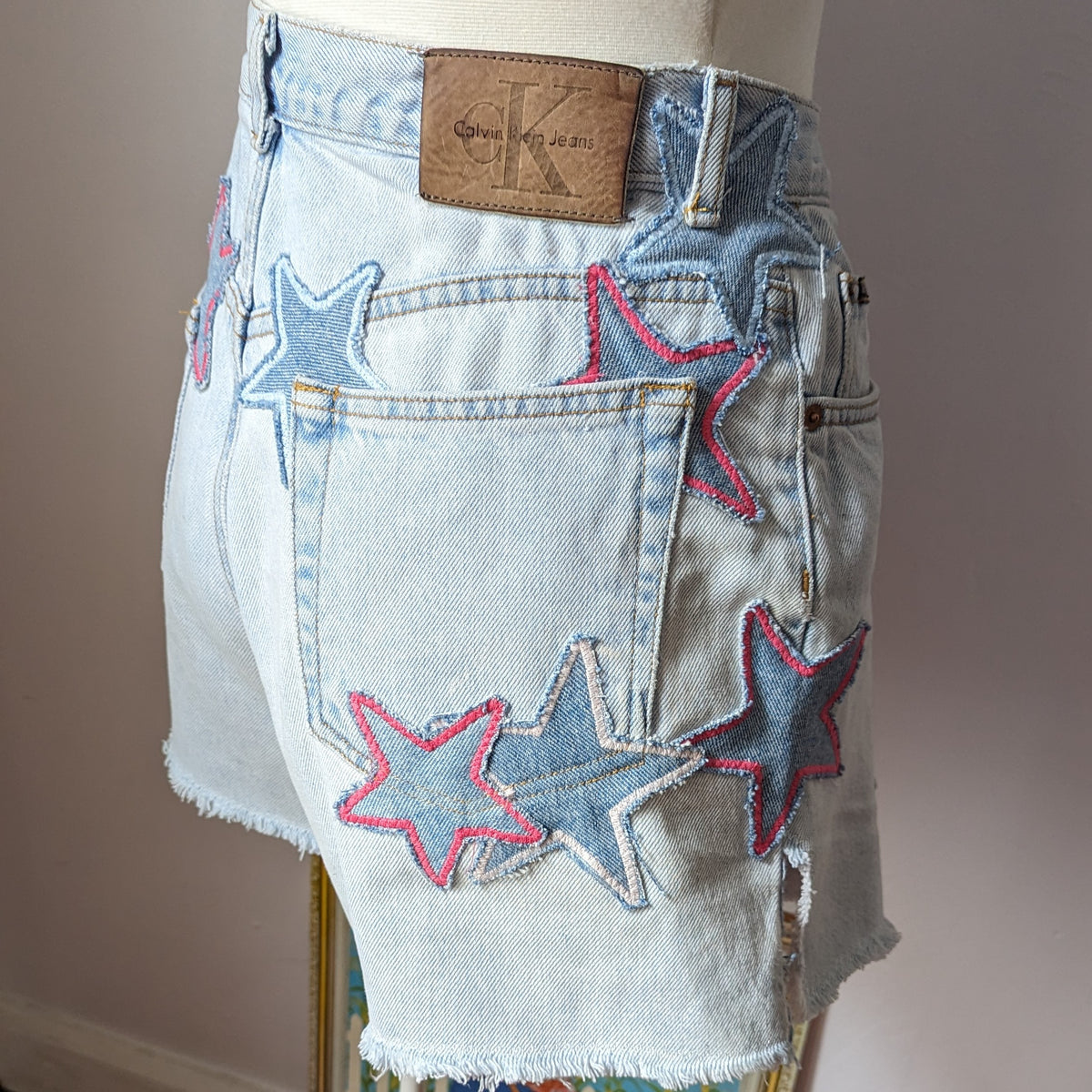 a woman's jean shorts with stars on it.