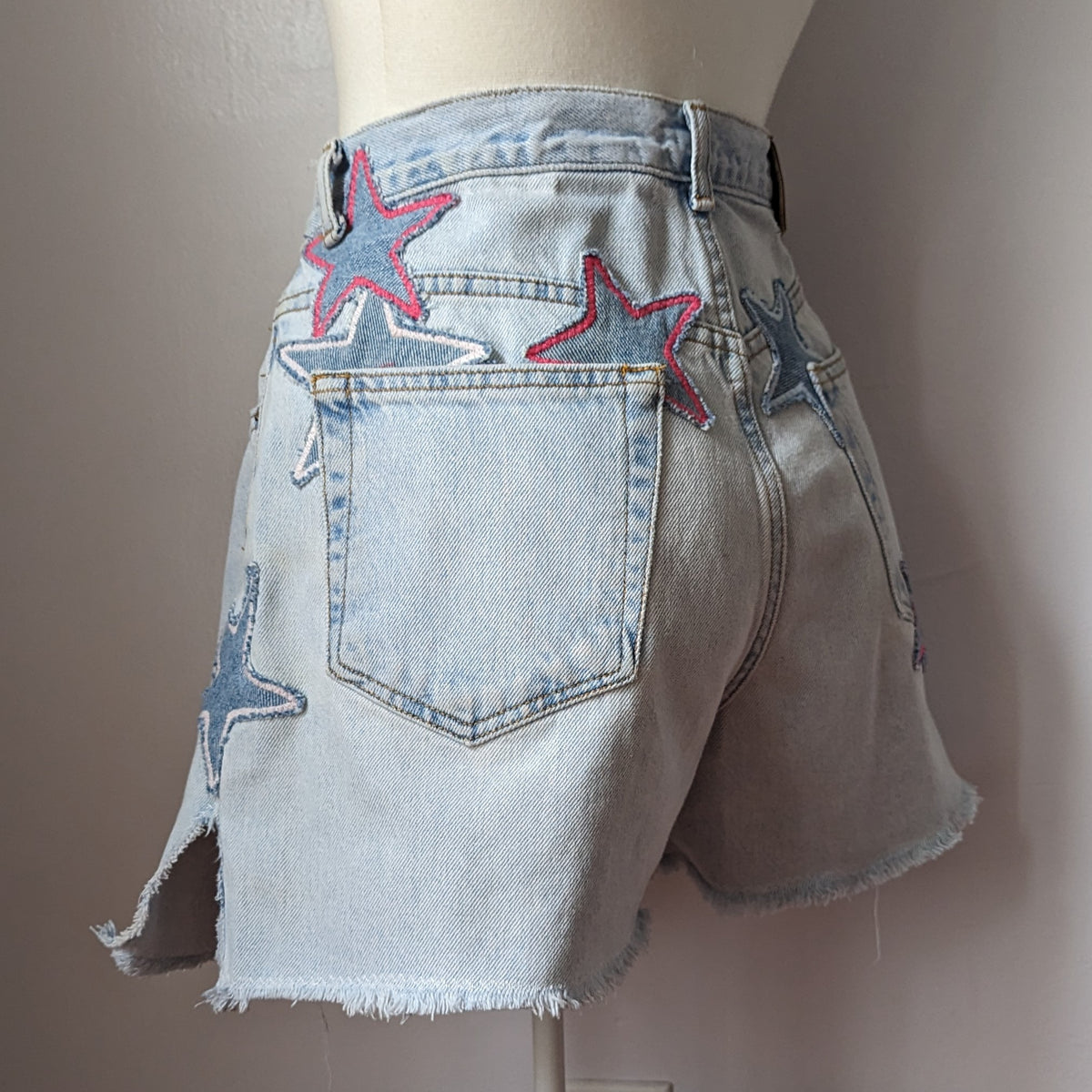 a mannequin wearing a pair of shorts with red, white and blue stars.