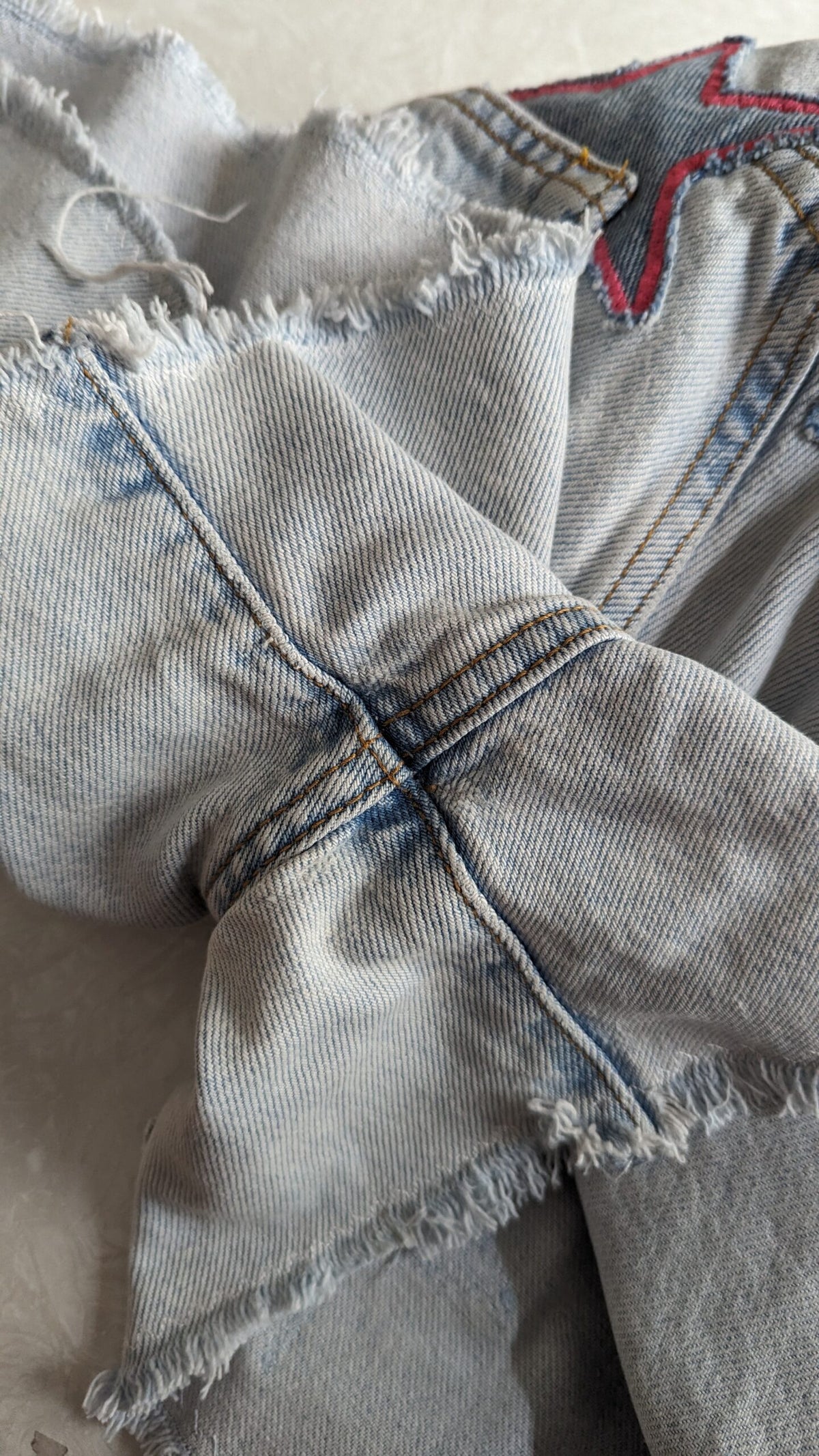 a close up of a pair of ripped jeans.