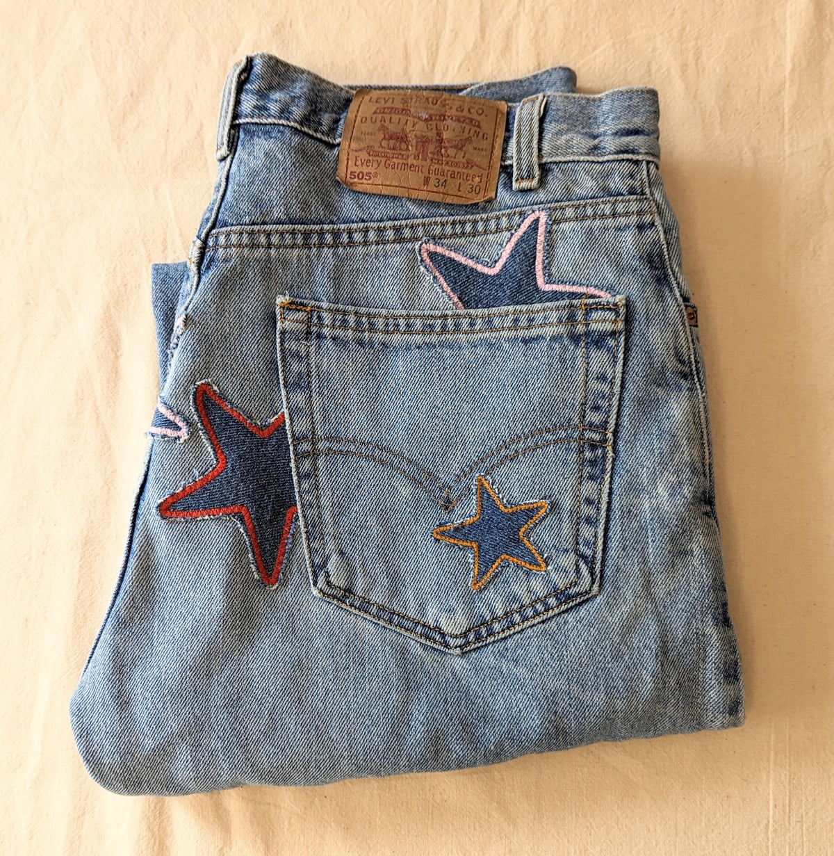 A pair of vintage Levi's jeans reworked with handmade patchwork stars