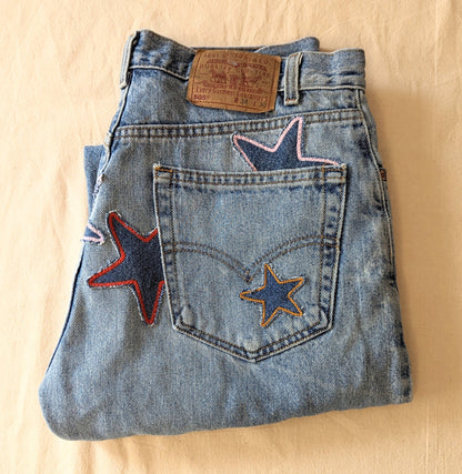 A pair of vintage Levi's jeans reworked with handmade patchwork stars