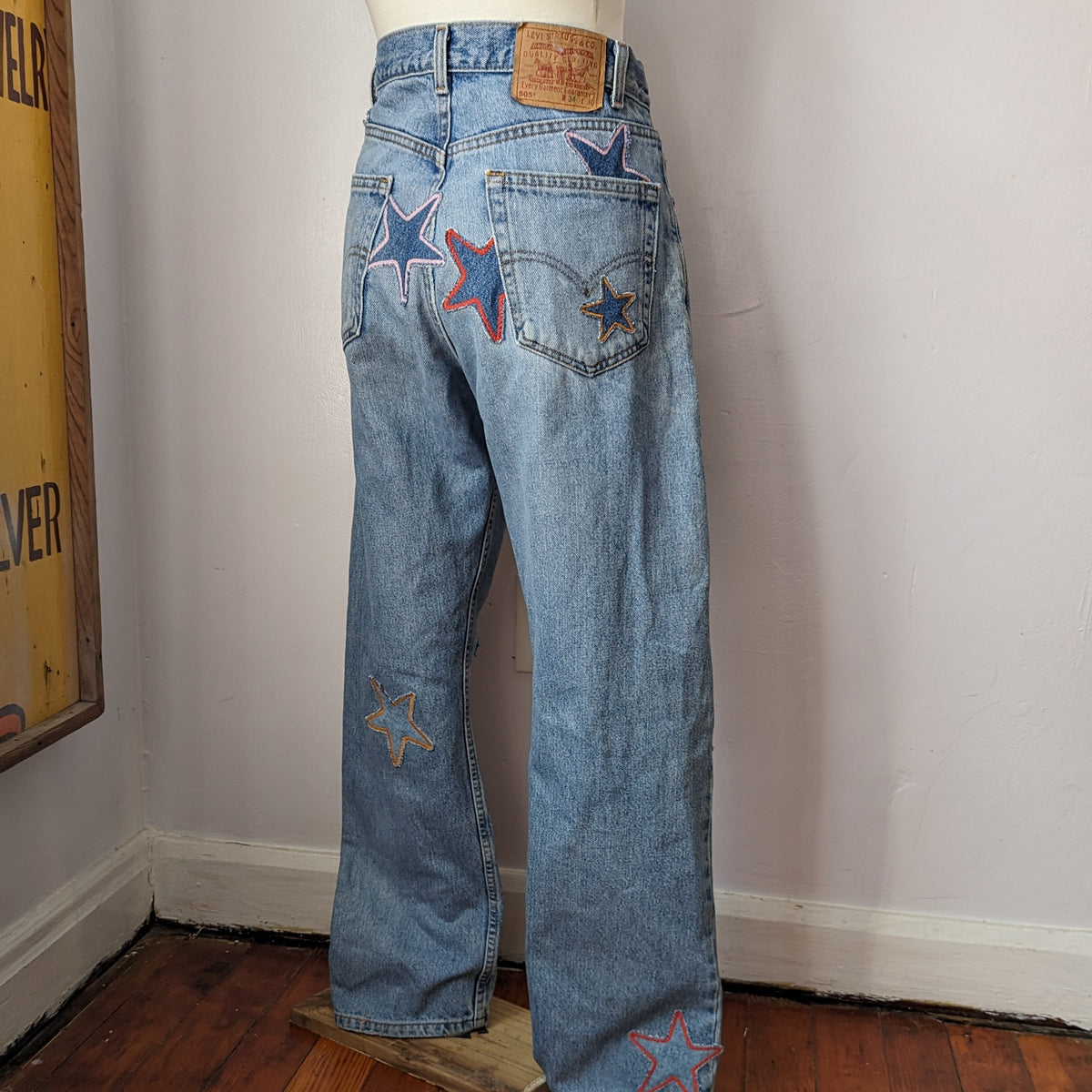 A mannequin wearing a pair of jeans with stars on them.