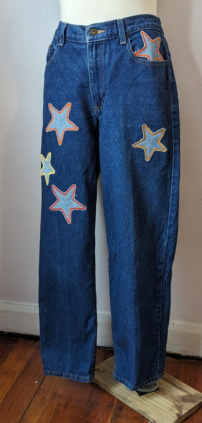 A pair of jeans with stars embroidered on them.