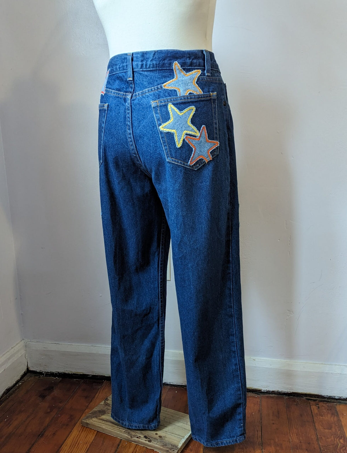 A mannequin wearing a pair of jeans with stars on them.