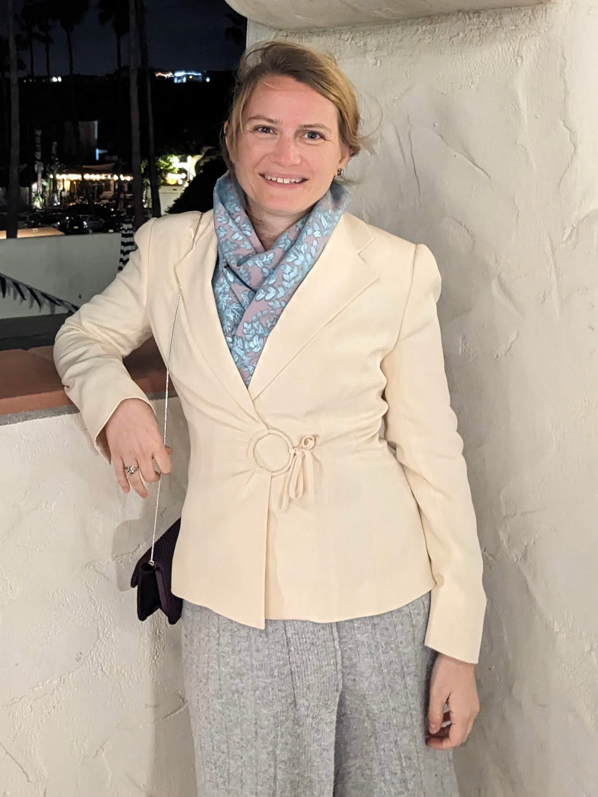 Lavender scarf with a shimmery turquoise fern design painted on, worn under a blazer