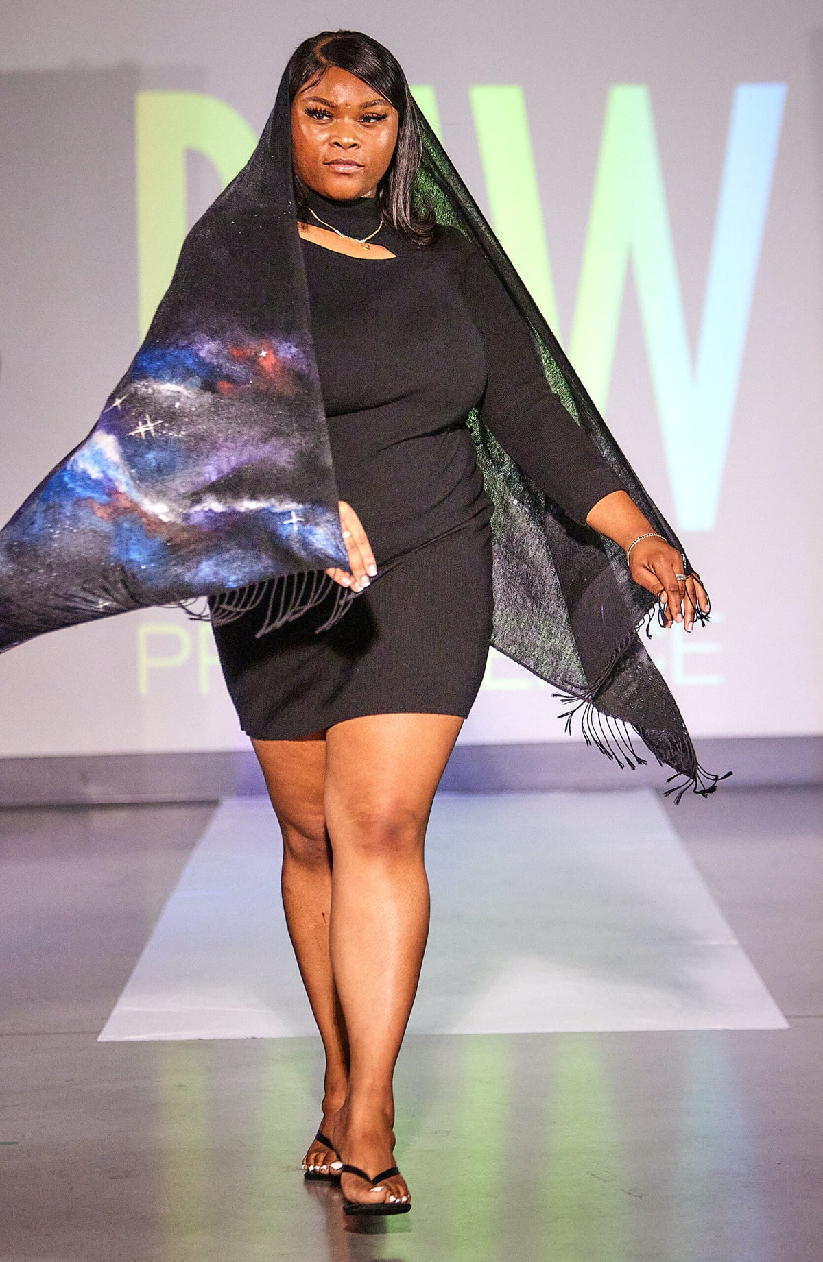 model on a runway wearing a hand-painted galaxy scarf