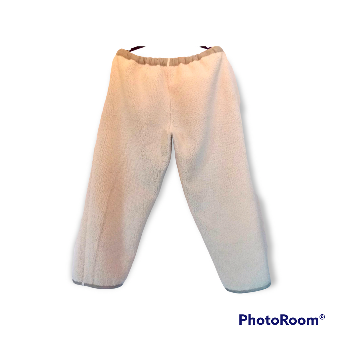 Revised Sentence: a pair of Sherpa sweatpants in white with a black stripe on the bottom.
