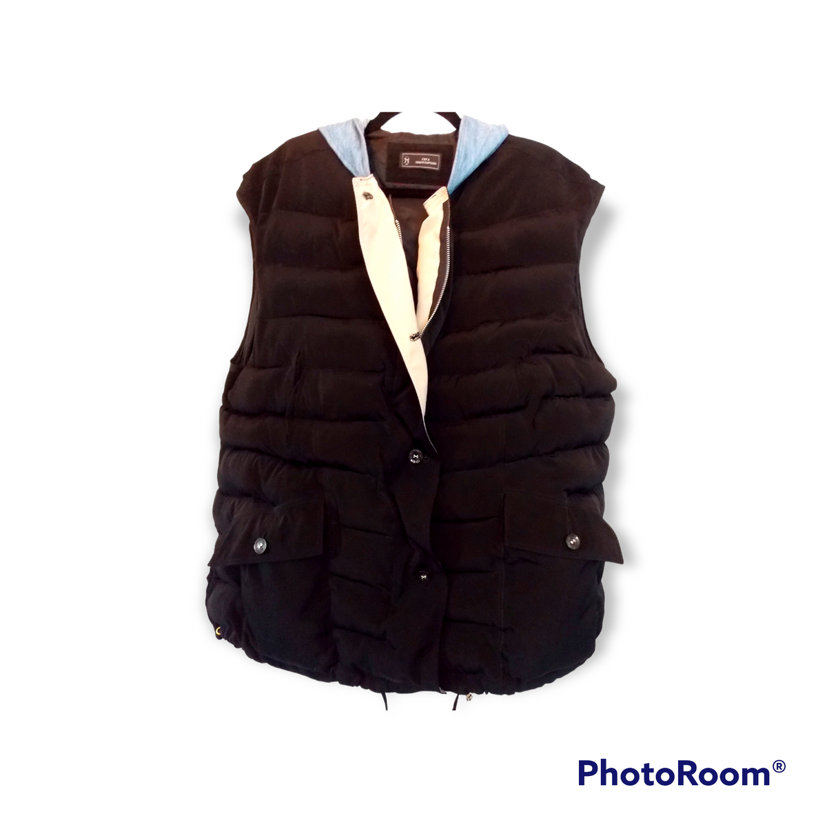 a black vest with a white shirt underneath it.